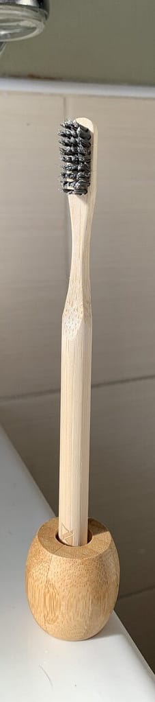 Acala Adult Bamboo Toothbrush standing in a Bamboo Toothbrush Holder. Both available at Nil Living - Newcastle.