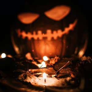 COP26 - Following the 3rd hottest October on record, a Halloween pumpkin glows in the light of a flame.